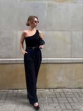 a lady wears a straight black pants with a black top